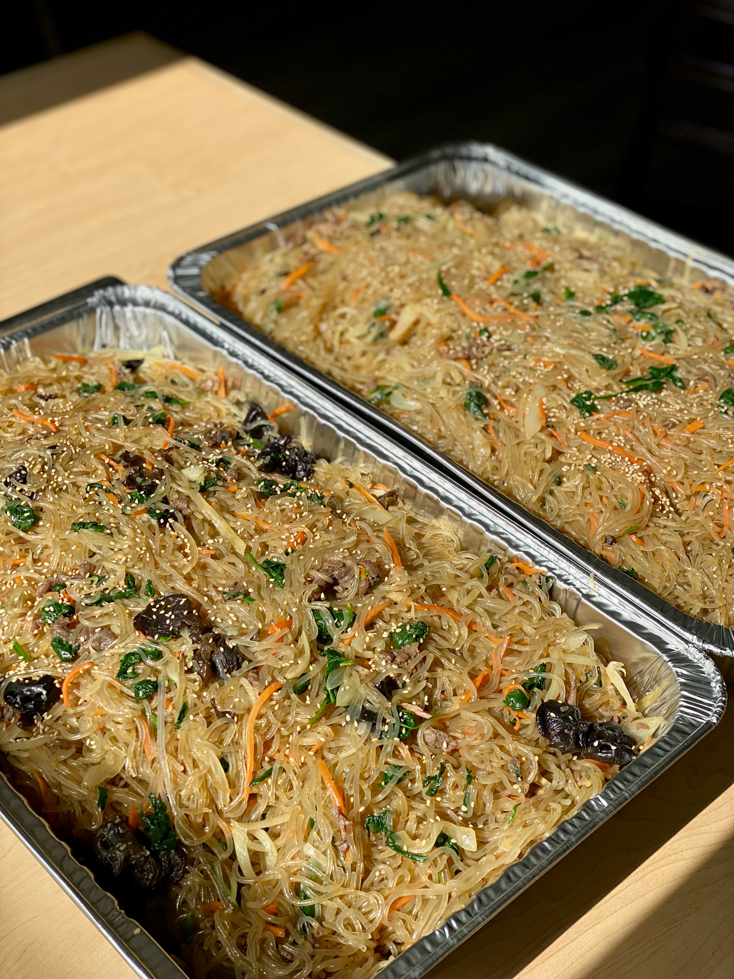 A catering tray of japchae from Cana Korean Restaurant