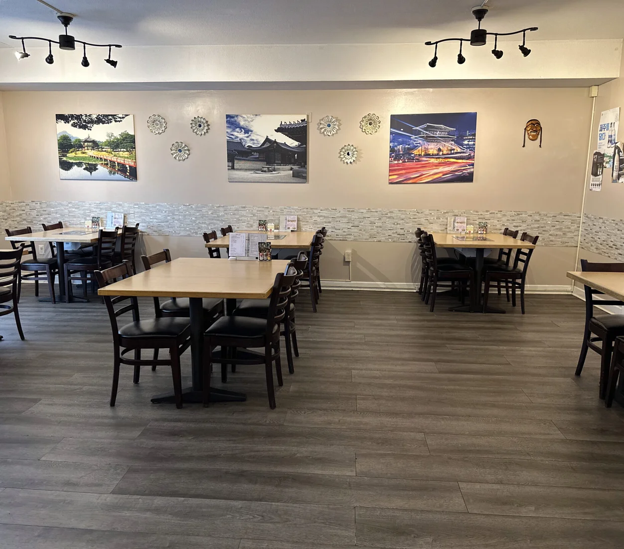 Indoor seating with beautiful Korean photography and artwork hanging from the walls at Cana Korean Restaurant