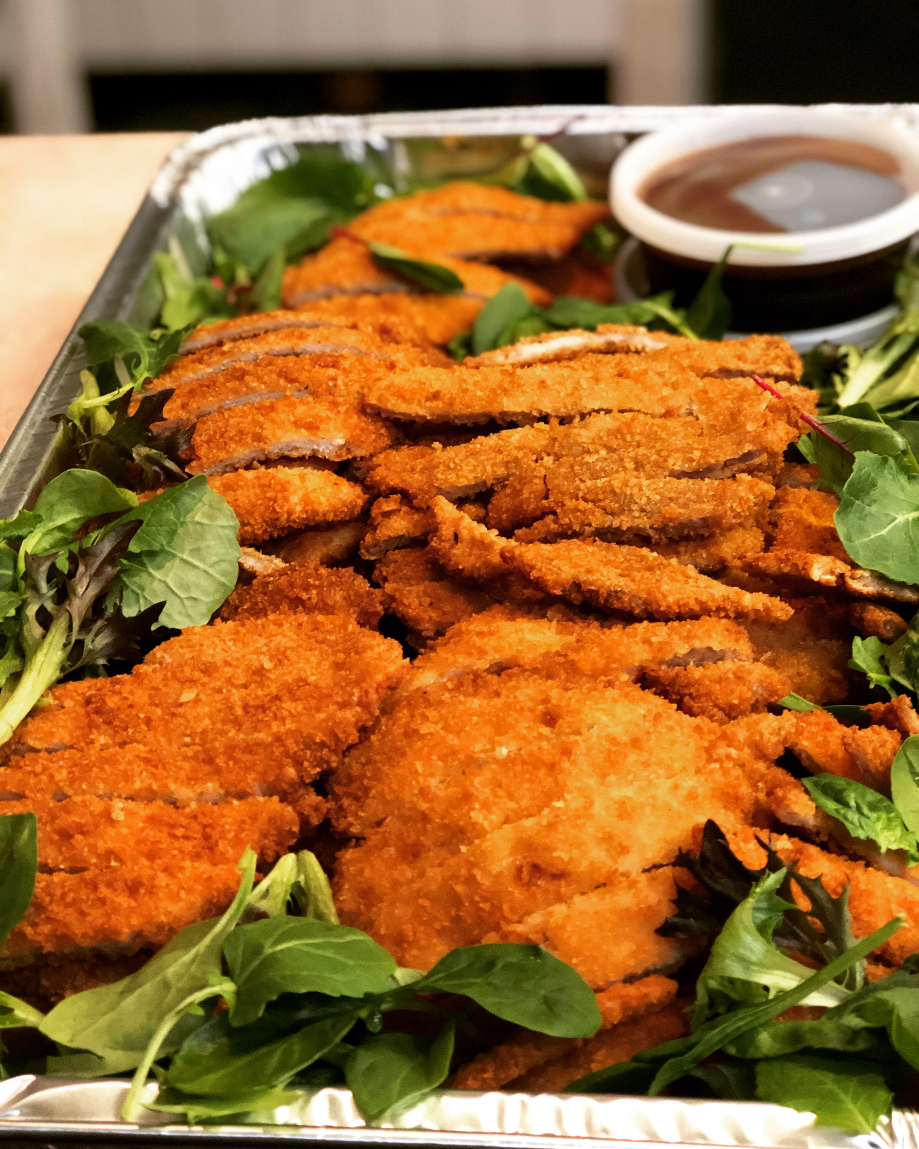 A catering tray of donkatsu, korean fried pork cutlet, from Cana Korean Restaurant