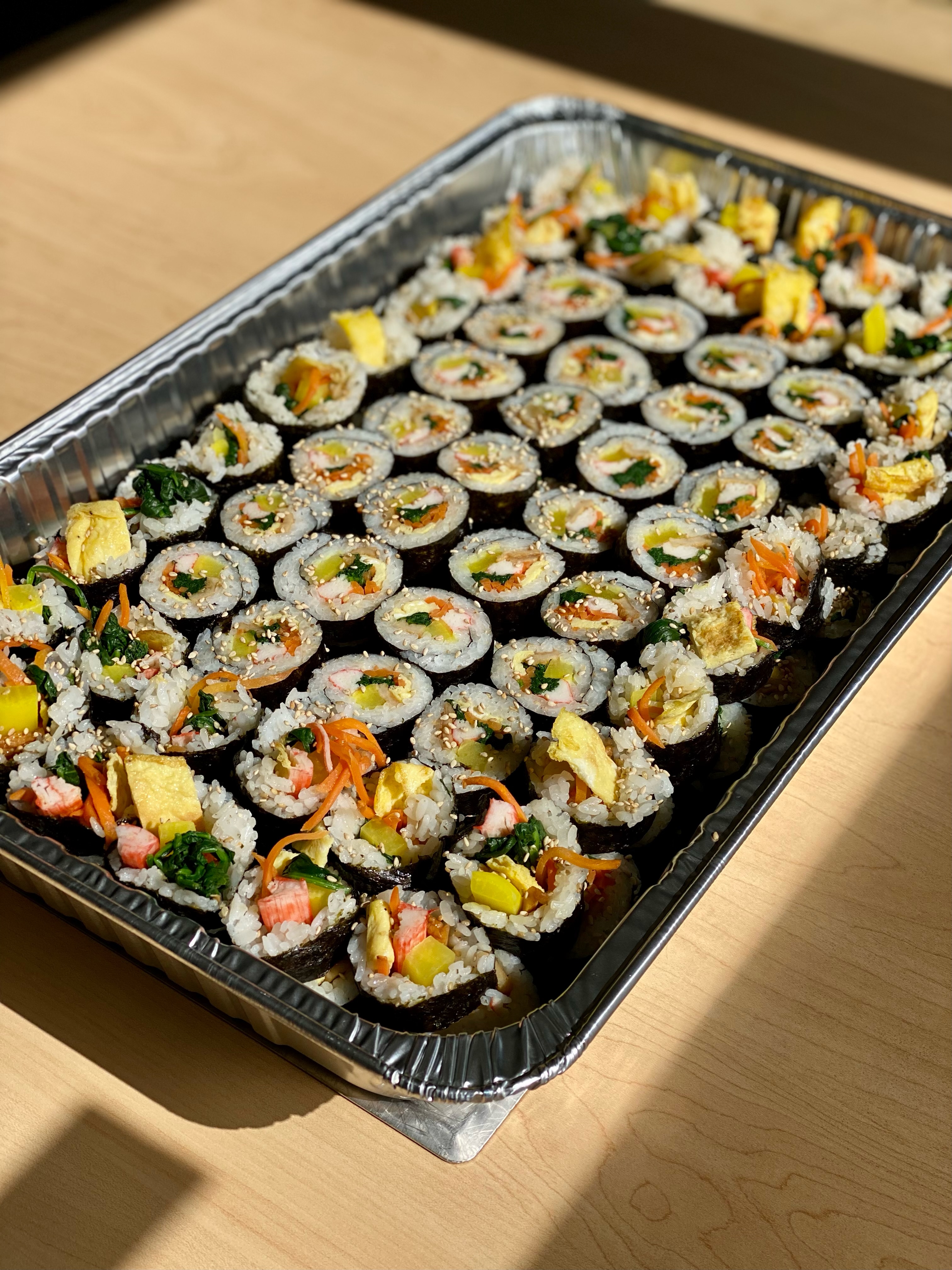 A catering tray of classic kimbap from Cana Korean Restaurant