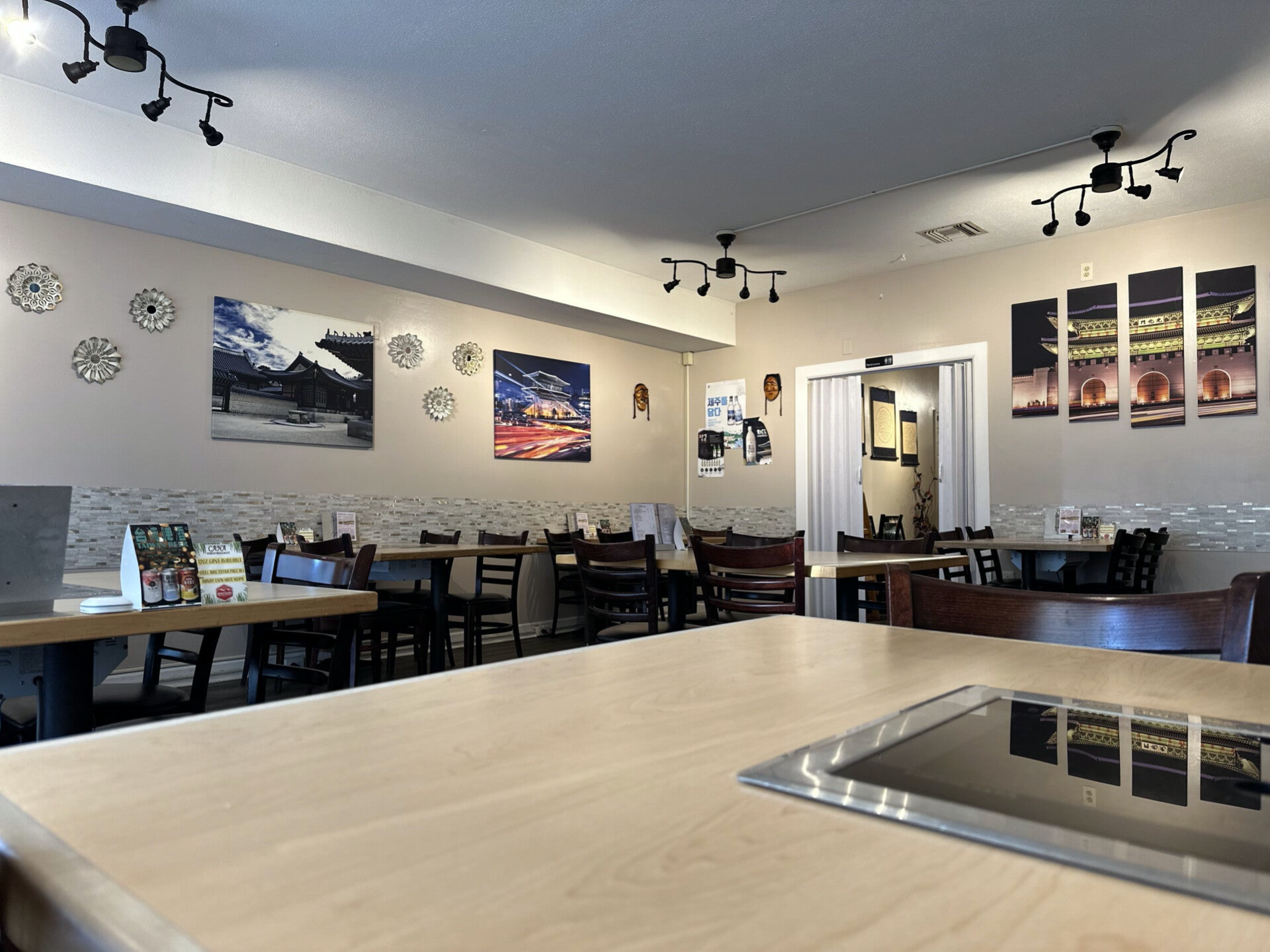 Indoor seating with visible tablestop stoves for Korean BBQ at Cana Korean Restaurant